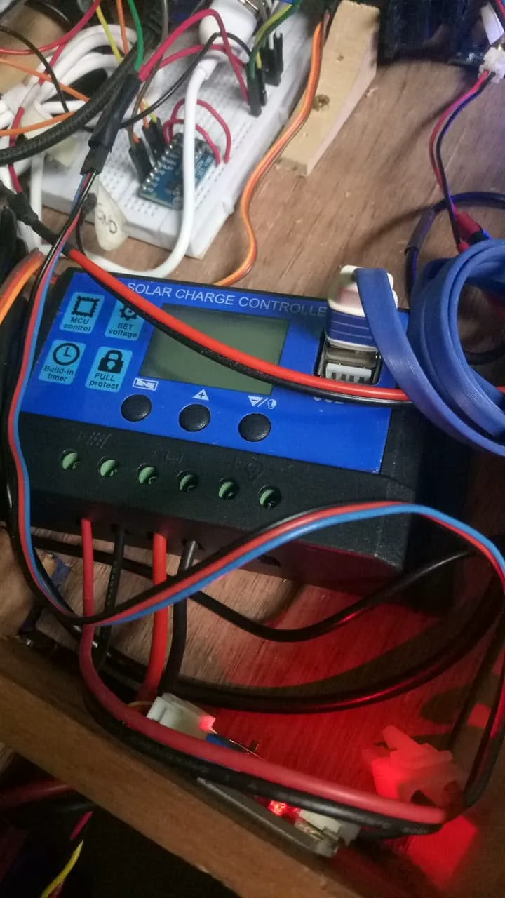 A solar charge controller wired up beside the breadboard and Arduino Pro Micro